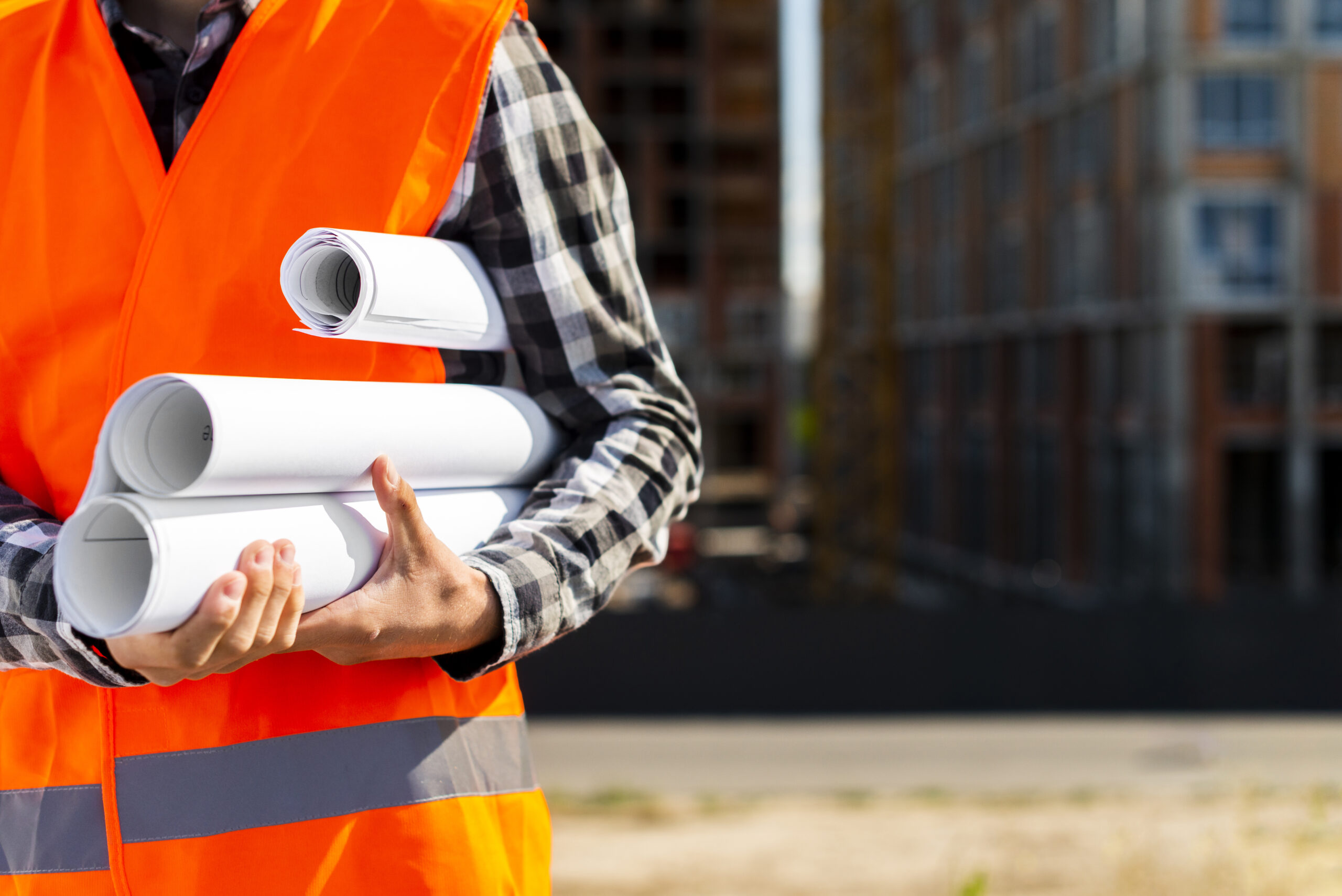 Person holding property surveying plans






