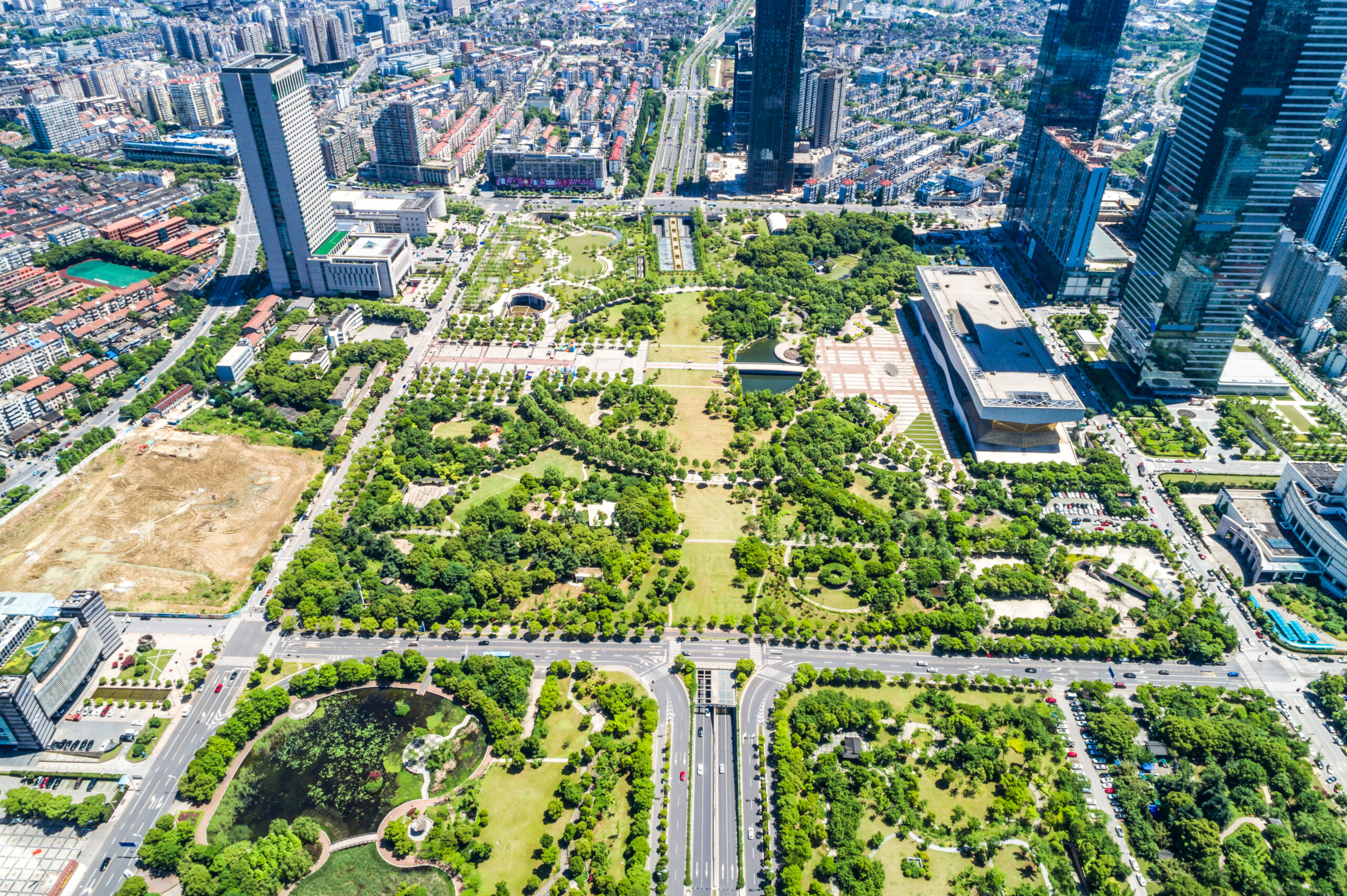 Aerial cityscape with green spaces.